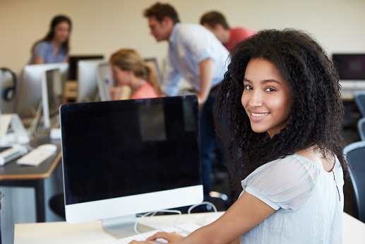 Digital Learning Female Student Using Computer In Classroom