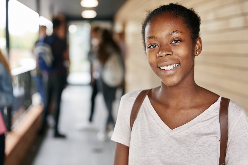 Portrait Of Female Teenage Student With Friends