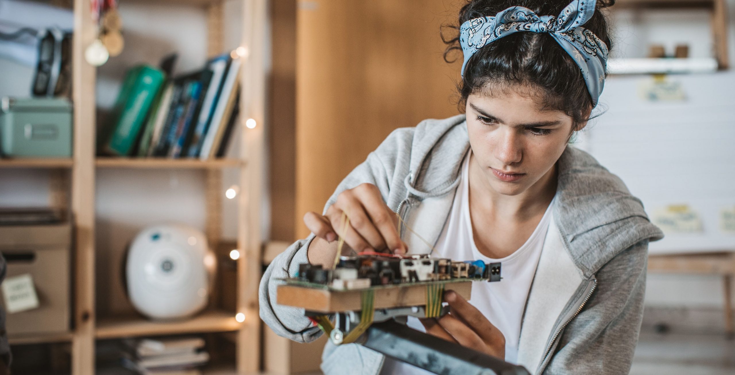 A high school girl working with electronics