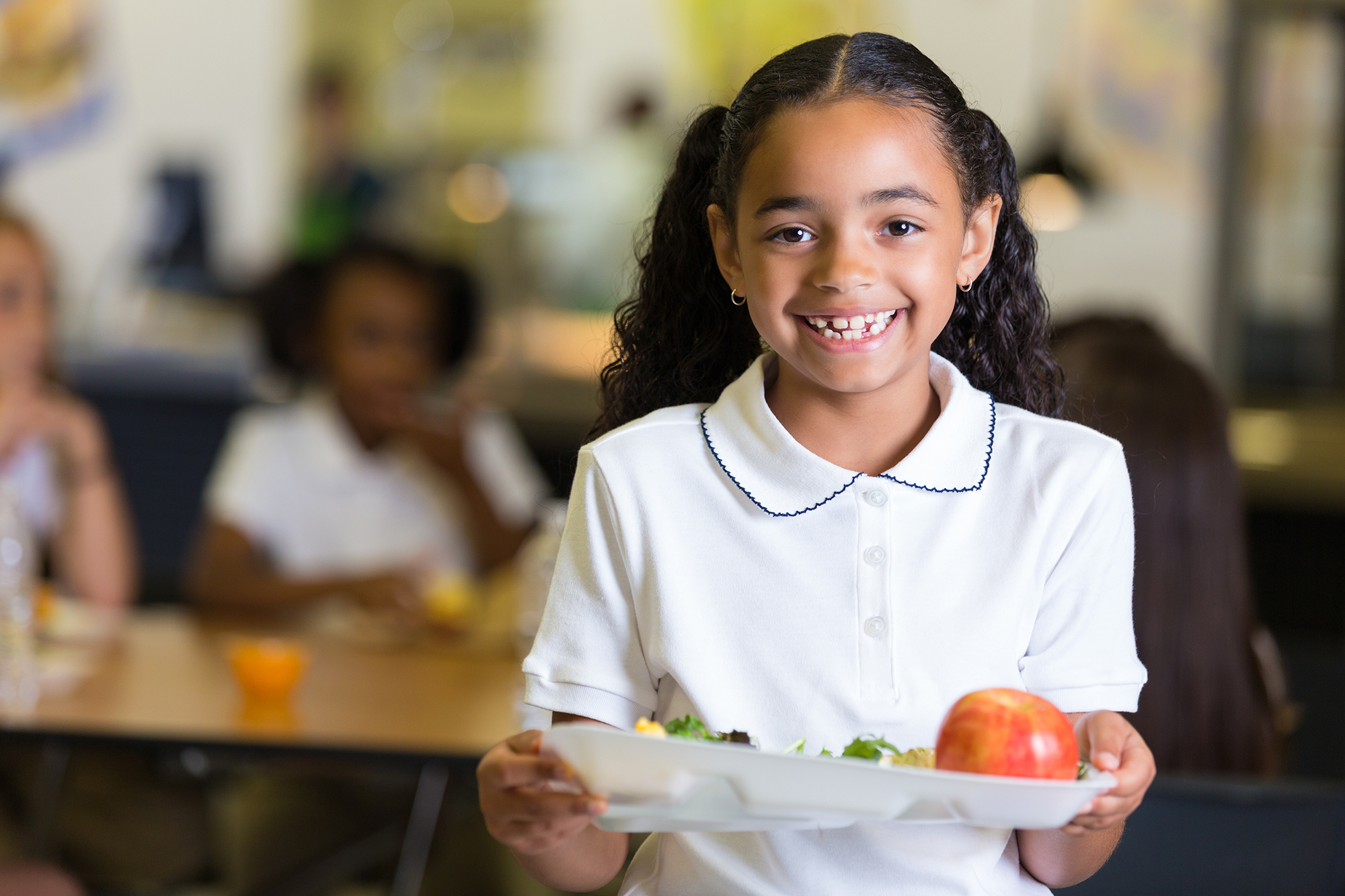 Cute little girl in school cafeteria with food tray Cute little girl in school cafeteria with food tray