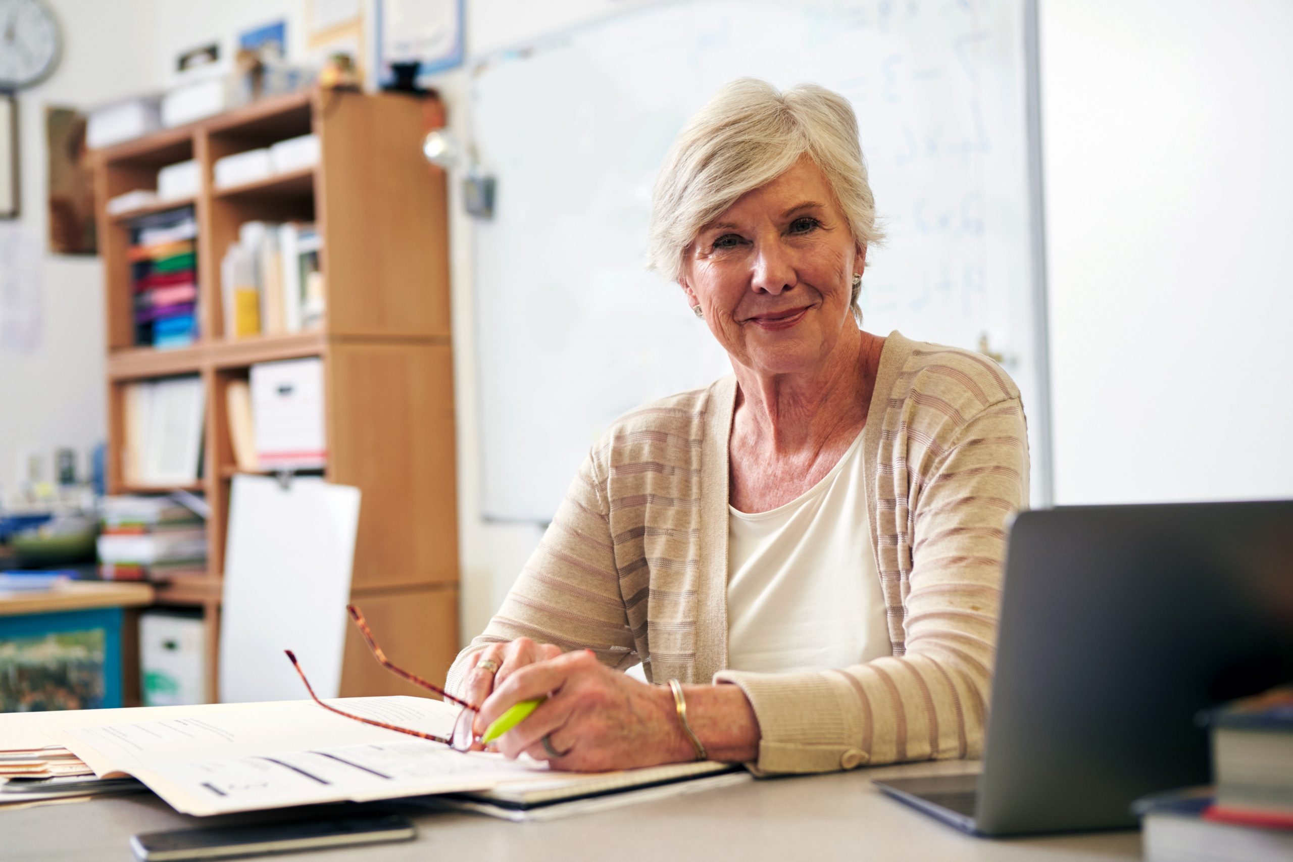 Portrait of senior female teacher working at her desk