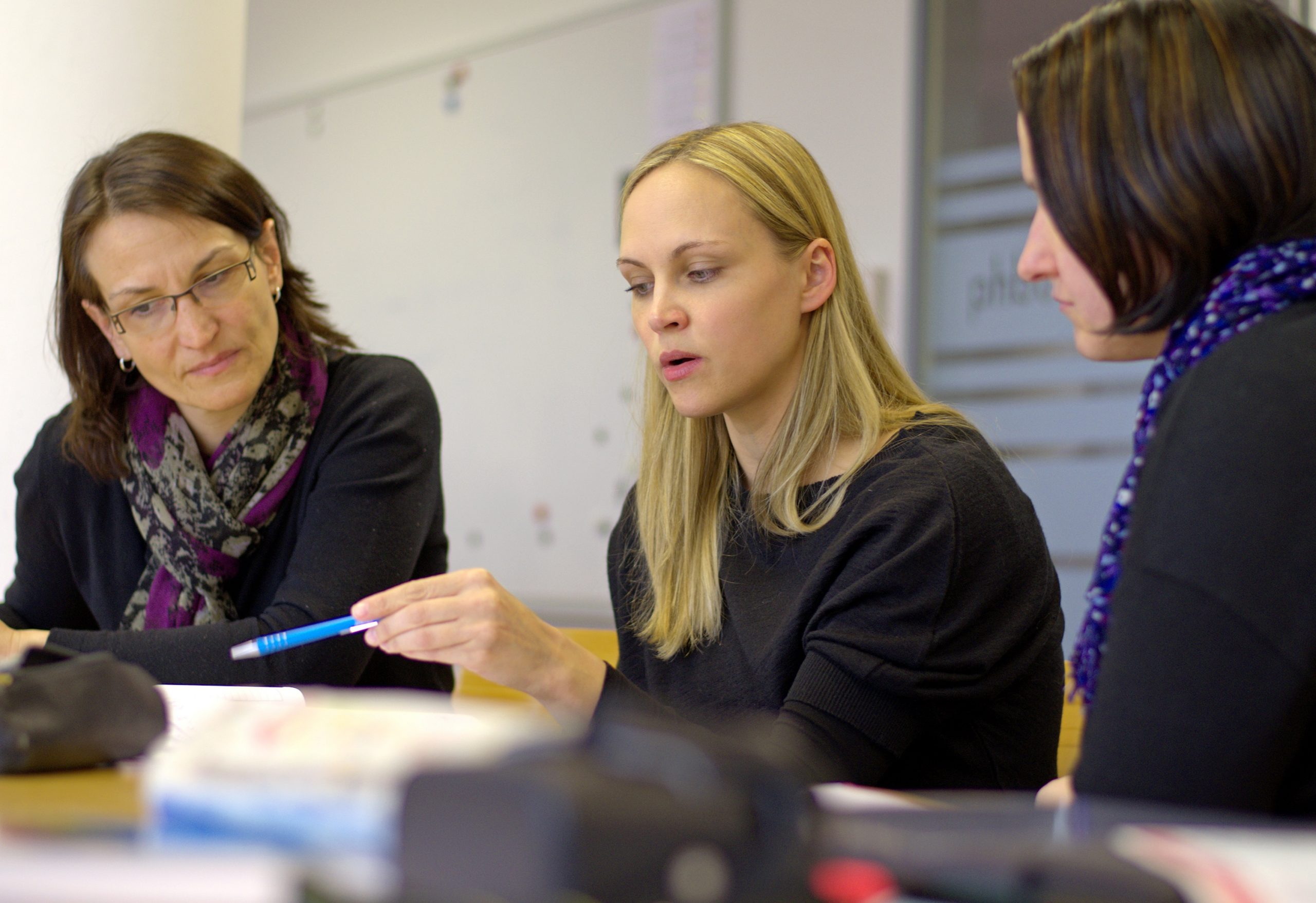 College program cover Female student working with two teachers