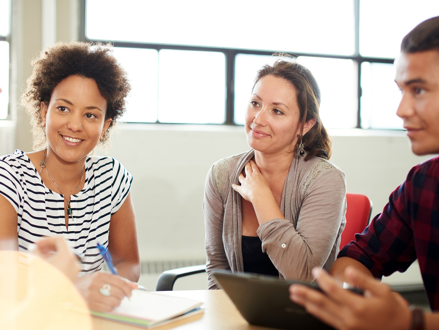 Team of adults collaborating around a table