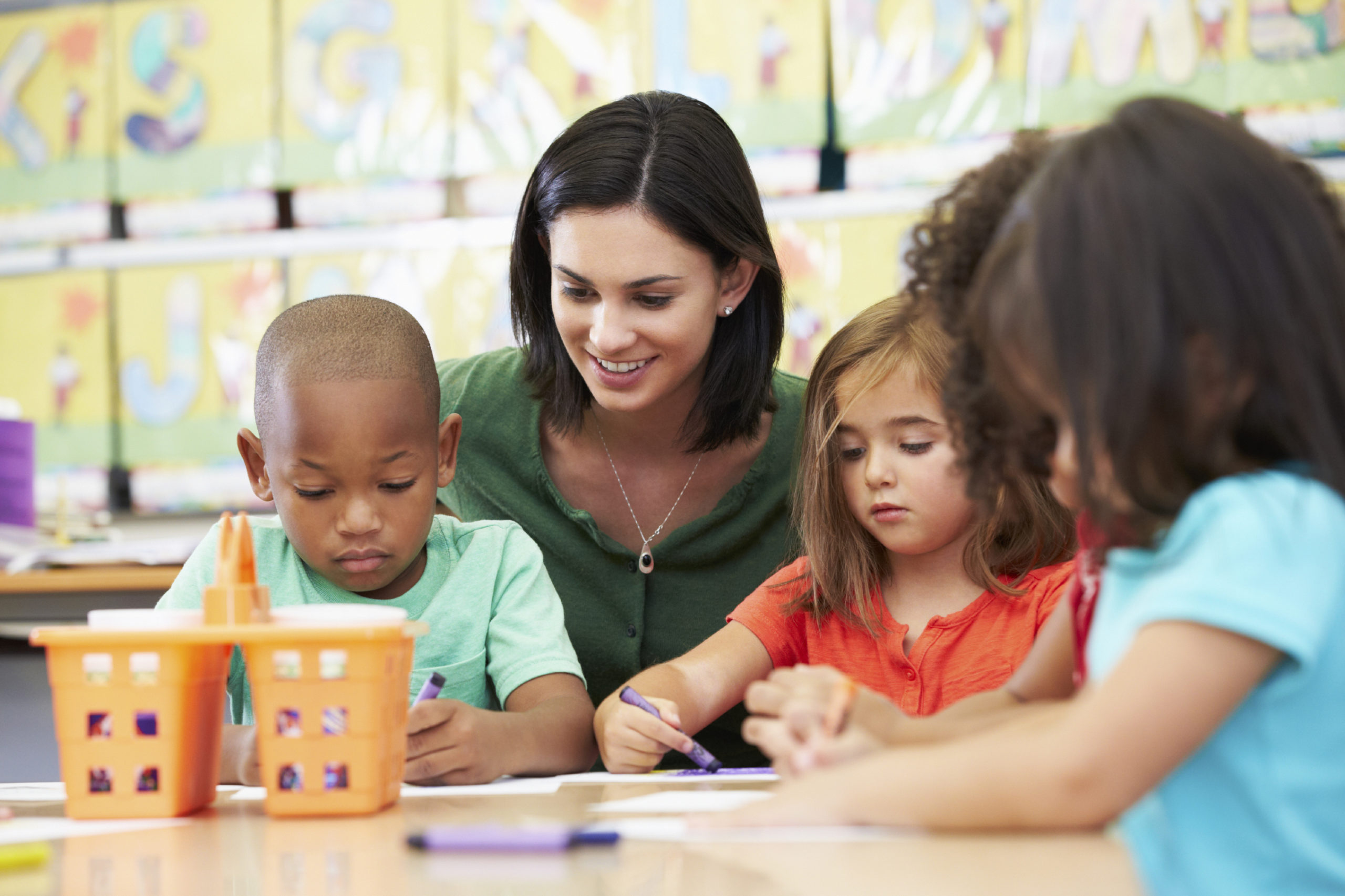 Children in early childhood classroom with teachers