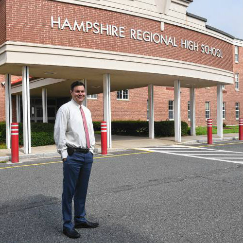 Superintendent Aaron Osborne standing in front of Hampshire Regional High School