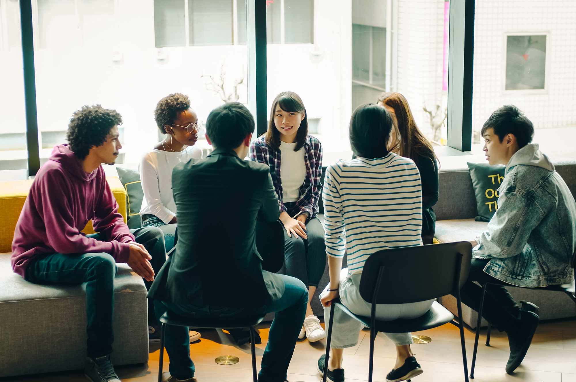 Group of adults and students talking in a circle