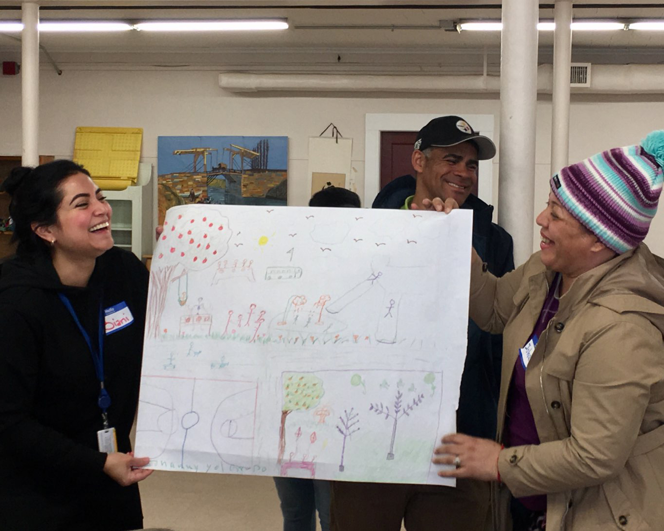 image of three people holding up a poster together and smiling